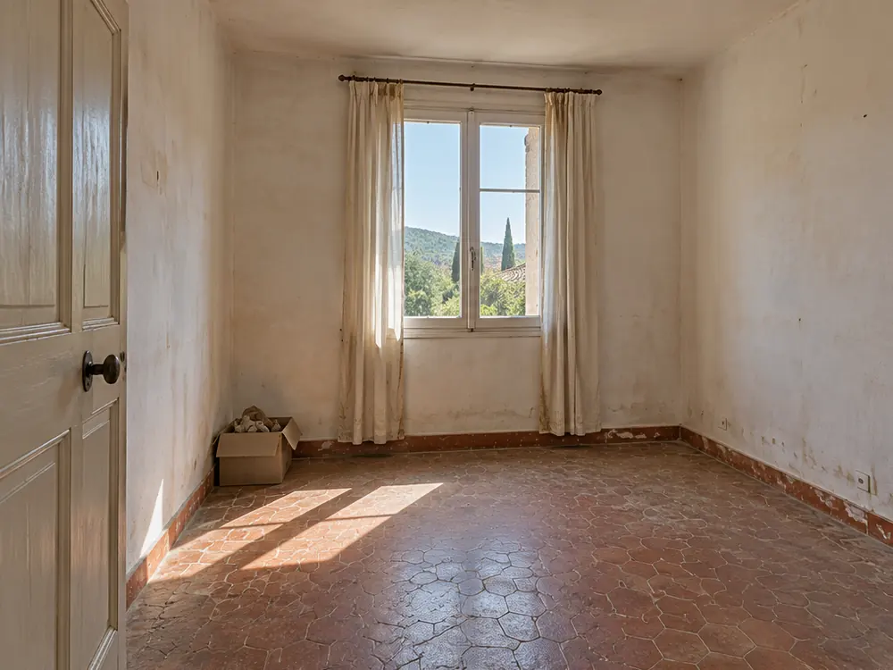 Simulation avant travaux : chambre vide aux tomettes, murs défraîchis